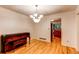 Bright dining room featuring hardwood floors, chandelier, window, and piano at 9614 W Powers Cir, Littleton, CO 80123