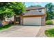 Lovely two-story home featuring a two-car garage and rock landscaping accents at 9614 W Powers Cir, Littleton, CO 80123