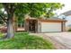Charming brick home with a well-maintained lawn and mature shade tree at 9614 W Powers Cir, Littleton, CO 80123