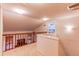 Bright hallway boasts natural light and a wood railing overlooking the living area at 9614 W Powers Cir, Littleton, CO 80123