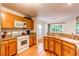 Well-lit kitchen with light wood cabinets, granite countertops and stainless steel appliances at 9614 W Powers Cir, Littleton, CO 80123