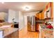 Spacious kitchen featuring light wood cabinets and stainless steel appliances at 9614 W Powers Cir, Littleton, CO 80123
