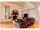 Cozy living room with a fireplace, large windows, and comfortable seating at 9614 W Powers Cir, Littleton, CO 80123