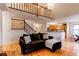 Spacious living room featuring a staircase, loft area, and an open view of the kitchen and dining area at 9614 W Powers Cir, Littleton, CO 80123