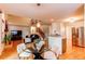 Open-concept living area with a staircase and view of the kitchen and dining area at 9614 W Powers Cir, Littleton, CO 80123