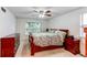 Spacious main bedroom features a ceiling fan, light-filled windows, and a comfortable bed at 9614 W Powers Cir, Littleton, CO 80123