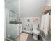 Compact bathroom featuring a shower with glass door, modern fixtures, and neutral color scheme at 800 S Krameria St, Denver, CO 80224