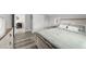 Inviting bedroom with wood-look bed frame, soft bedding, and view towards dining area at 800 S Krameria St, Denver, CO 80224