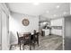 Open dining area adjacent to kitchen and living space, with dark wood table, seating for four at 800 S Krameria St, Denver, CO 80224