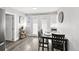 Bright dining area with dark wood table, seating for four, and double doors to the outside at 800 S Krameria St, Denver, CO 80224