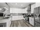 Modern kitchen with stainless steel appliances, white cabinets, and granite countertops at 800 S Krameria St, Denver, CO 80224