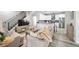 Open-concept living room with hardwood floors, neutral furniture, and a view of the modern kitchen at 800 S Krameria St, Denver, CO 80224