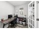 Functional study featuring a modern desk, ergonomic chair, storage unit and outdoor views at 800 S Krameria St, Denver, CO 80224