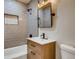 Modern bathroom with gray tile and wood vanity at 2290 S Irving St, Denver, CO 80219