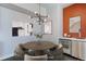 Dining area with a round table, stylish chairs, modern lighting, and a wine fridge at 2460 W 29Th Ave # 303, Denver, CO 80211