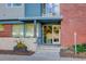 Building entrance with glass doors and brick facade at 2460 W 29Th Ave # 303, Denver, CO 80211