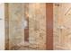 Luxurious shower with stone walls, rain shower head, and glass door at 2460 W 29Th Ave # 303, Denver, CO 80211