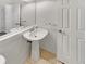 Clean half-bathroom with pedestal sink and white fixtures at 124 High Country Trl, Lafayette, CO 80026