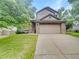 Charming two-story home with a two-car garage and stone accents, nestled in a well-manicured lawn at 124 High Country Trl, Lafayette, CO 80026
