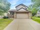 Charming two-story home with a two-car garage and stone accents, nestled in a well-manicured lawn at 124 High Country Trl, Lafayette, CO 80026