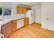 Well-lit kitchen with wooden cabinets and white appliances at 124 High Country Trl, Lafayette, CO 80026