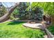 Landscaped backyard with a flagstone patio and built-in fire pit, perfect for gatherings at 3314 Astorbrook Cir, Highlands Ranch, CO 80126