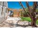Backyard features a stone patio area, mature trees, and a pergola over a patio at 3314 Astorbrook Cir, Highlands Ranch, CO 80126
