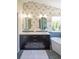 Bathroom with modern vanity, designer wallpaper, and soaking tub exudes sophistication at 3314 Astorbrook Cir, Highlands Ranch, CO 80126