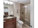 Modern bathroom with a glass-enclosed shower, granite countertop, and stylish vanity at 3314 Astorbrook Cir, Highlands Ranch, CO 80126