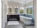 Elegant bathroom with soaking tub, stylish wallpaper, and dual vanity is luxurious at 3314 Astorbrook Cir, Highlands Ranch, CO 80126