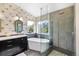 Stylish bathroom features dual sinks, soaking tub, and a glass-enclosed shower at 3314 Astorbrook Cir, Highlands Ranch, CO 80126