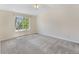 Light-filled bedroom with large window and neutral carpet is move-in ready at 3314 Astorbrook Cir, Highlands Ranch, CO 80126