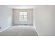 Minimalist bedroom featuring neutral carpet and a window to bring in natural light at 3314 Astorbrook Cir, Highlands Ranch, CO 80126