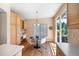 Bright breakfast nook with natural light, built-in desk and table, and hardwood floors at 3314 Astorbrook Cir, Highlands Ranch, CO 80126