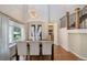 Elegant dining area featuring a modern chandelier, large windows, and hardwood floors at 3314 Astorbrook Cir, Highlands Ranch, CO 80126