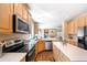Bright kitchen features stainless steel appliances, wood floors, and a seamless connection to the living area at 3314 Astorbrook Cir, Highlands Ranch, CO 80126