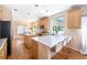Spacious kitchen with eat-in island, wood floors, stainless appliances, and a bright eating area at 3314 Astorbrook Cir, Highlands Ranch, CO 80126