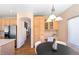 Bright breakfast nook with natural light, built-in desk and table, and hardwood floors at 3314 Astorbrook Cir, Highlands Ranch, CO 80126