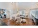 Bright, open-concept living area with high ceilings, hardwood floors, and abundant natural light at 3314 Astorbrook Cir, Highlands Ranch, CO 80126