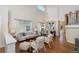 Bright, open-concept living area with high ceilings, hardwood floors, and abundant natural light at 3314 Astorbrook Cir, Highlands Ranch, CO 80126