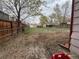 A spacious backyard area with a mix of grass and gravel and dirt, surrounded by fences at 5363 W 4Th Ave, Lakewood, CO 80226