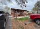 A single story home with brick and siding, small porch, and parking area, on an overcast day at 5363 W 4Th Ave, Lakewood, CO 80226