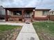Quaint brick home featuring a cozy front porch with pillars and a short walkway to the front door at 5363 W 4Th Ave, Lakewood, CO 80226