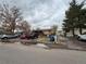 Modest single story home with brick and siding, multiple vehicles parked in the front at 5363 W 4Th Ave, Lakewood, CO 80226