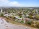 Aerial view of a quiet neighborhood featuring mature trees, well maintained lawns, and a long mural at 690 W 1St Ave, Broomfield, CO 80020