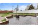Beautiful backyard featuring a stone fire pit and a well-maintained lawn, perfect for outdoor gatherings at 690 W 1St Ave, Broomfield, CO 80020
