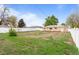 Backyard featuring a large fenced in yard space with mixed landscaping and sunny exposure at 690 W 1St Ave, Broomfield, CO 80020
