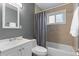 Cozy bathroom with a shower-tub combination, tiled walls, and neutral tones at 690 W 1St Ave, Broomfield, CO 80020