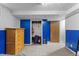 Bedroom featuring a dresser, carpeted floors, blue accent wall, and an open closet at 690 W 1St Ave, Broomfield, CO 80020