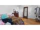 Bedroom featuring hardwood floors, a full length mirror, and neutral paint at 690 W 1St Ave, Broomfield, CO 80020
